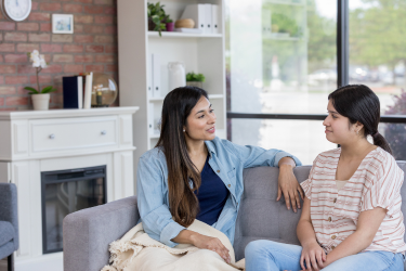 Parent and child talking on a couch
